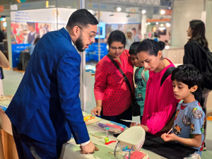 Specialist talking with parents and children at a child development event