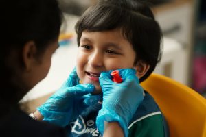 Therapist working with a young boy during a speech and oral motor session